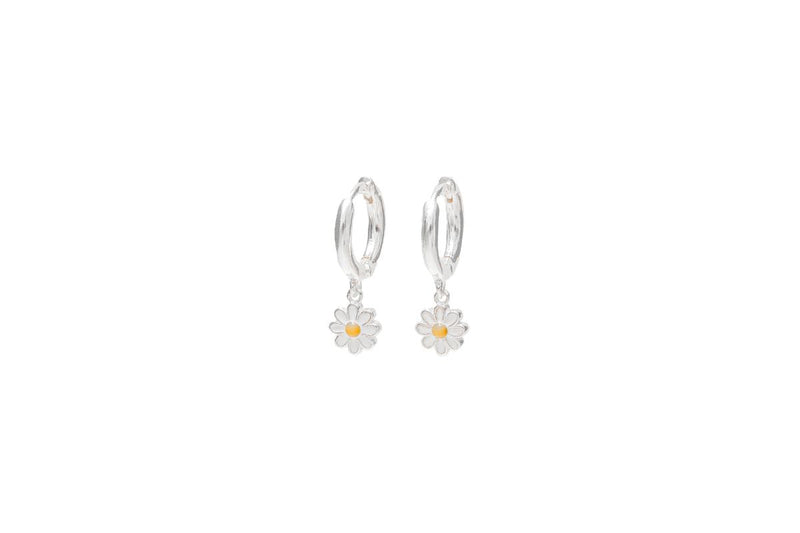 A pair of sterling silver huggie earrings with a single daisy design on a white background.