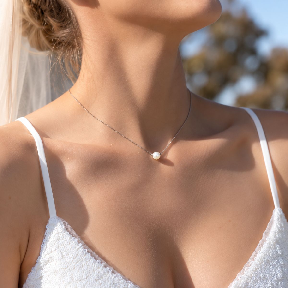 classic pearl necklace around bride's neck