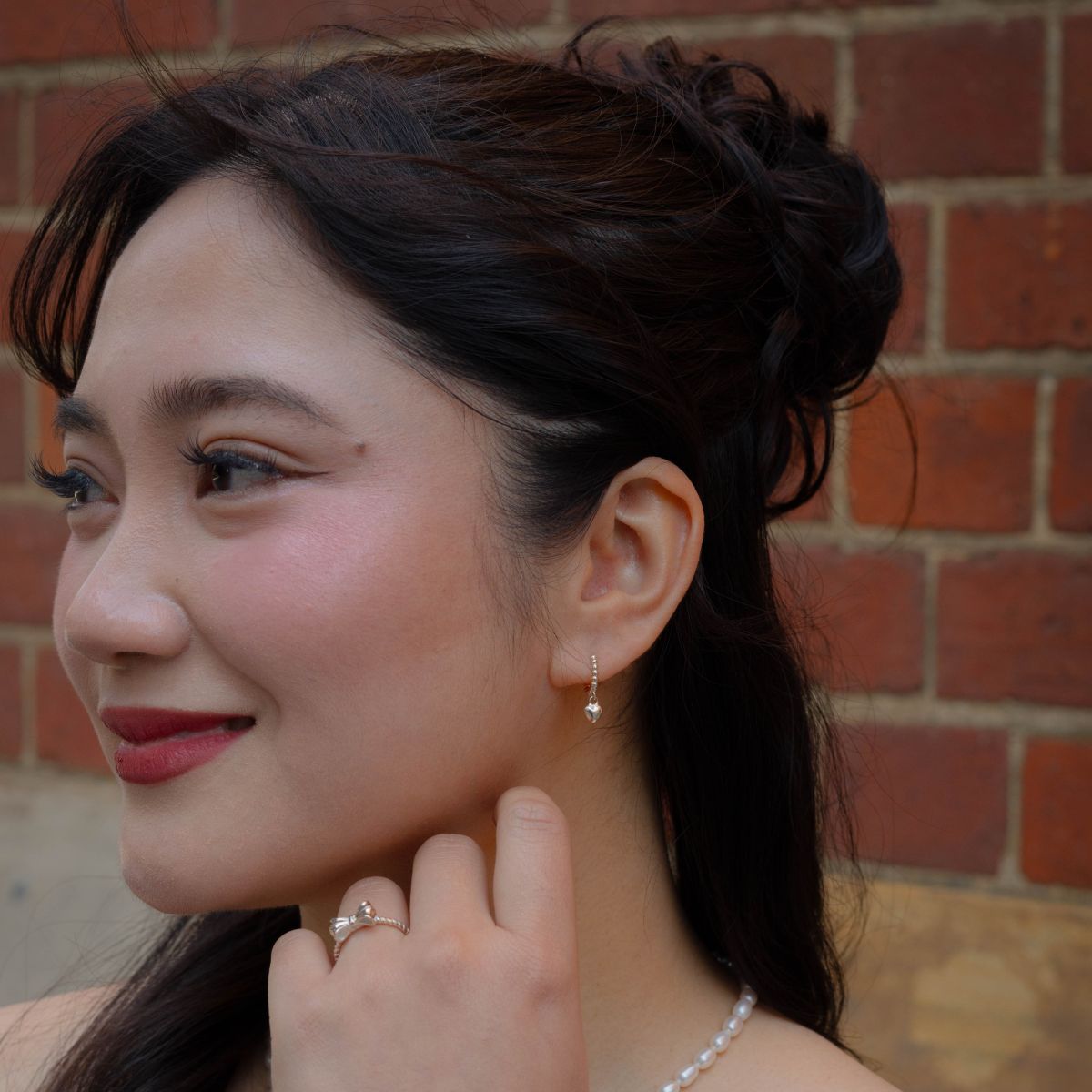 Woman wearing Sweet Love Sterling Silver Earrings 