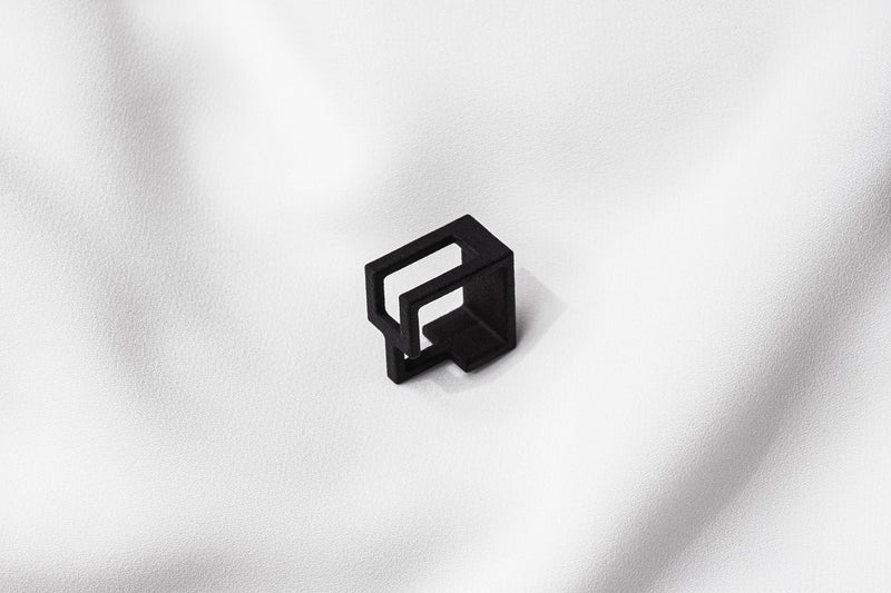 A matte black ring with a minimalist design, 3D printed from sustainable PA12 nylon, displayed on a white background.