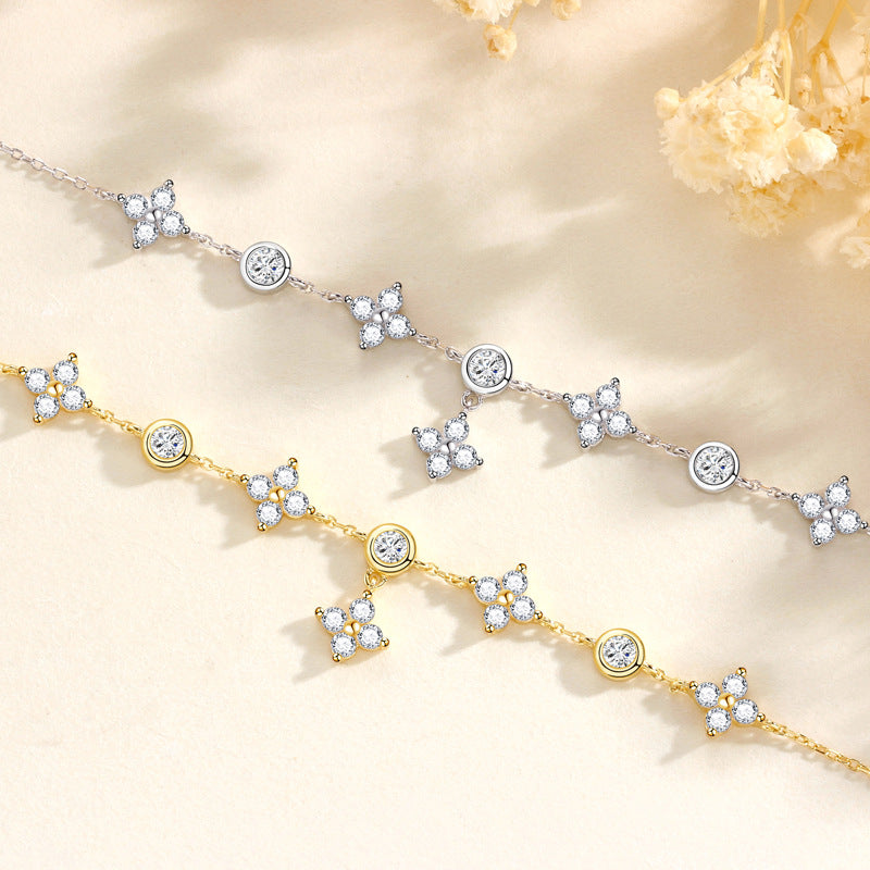 A gold and a silver bracelet featuring cubic zirconias on a floral background