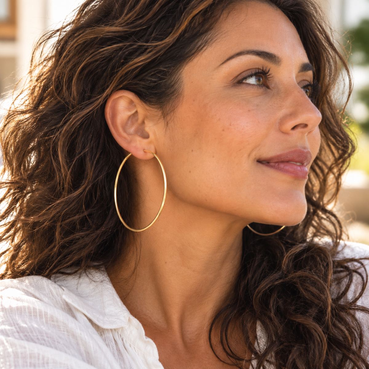 gold vermeil sterling silver 6cm hoops worn by a woman