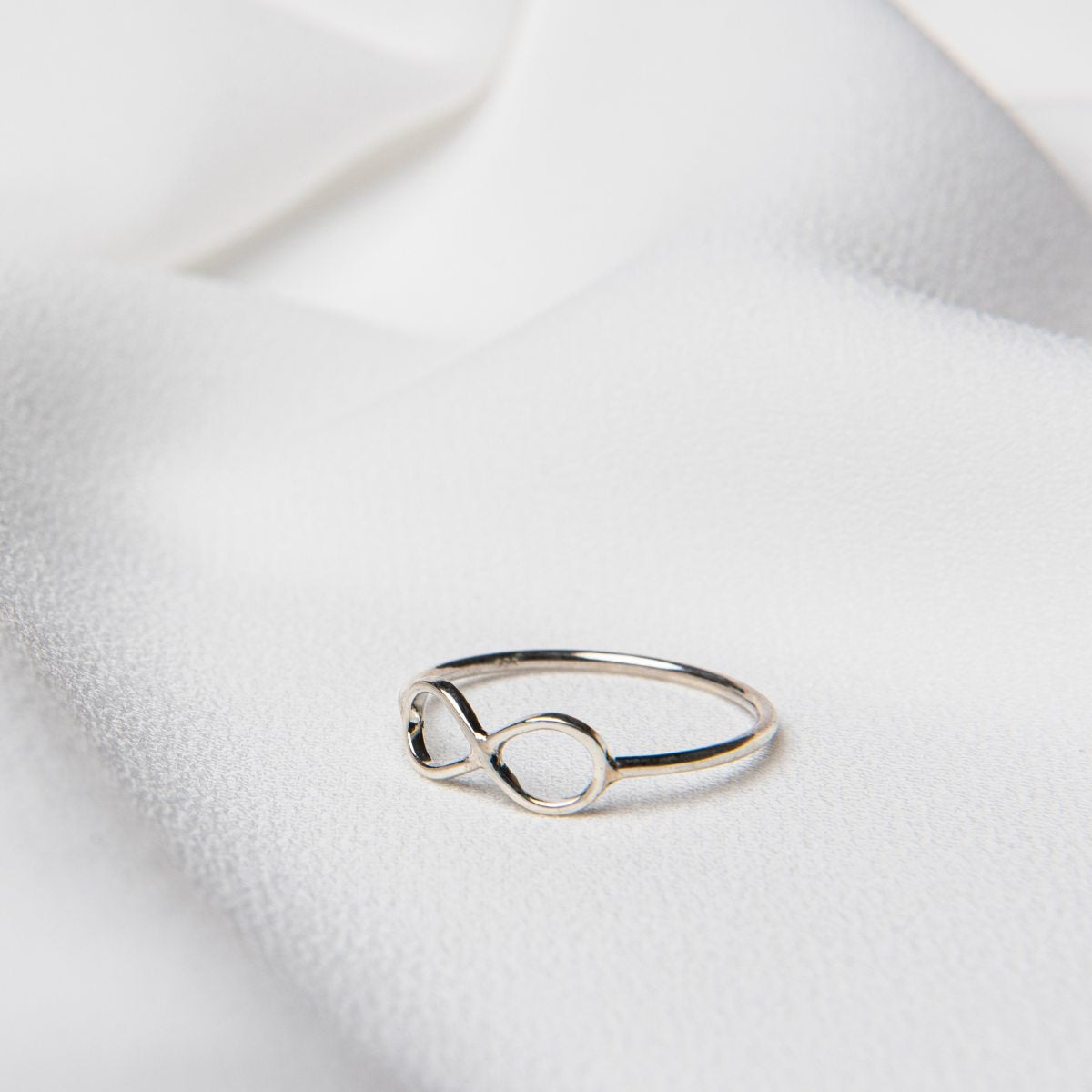 sterling silver infinity ring on white background