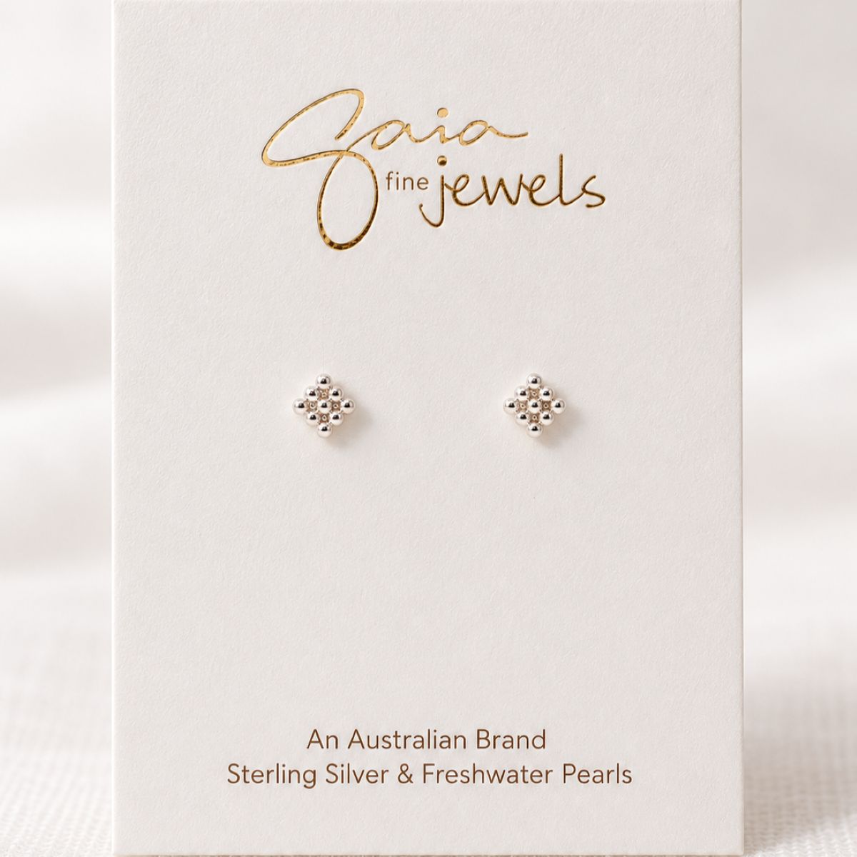 sterling silver studs with 9 dots detail on earring card