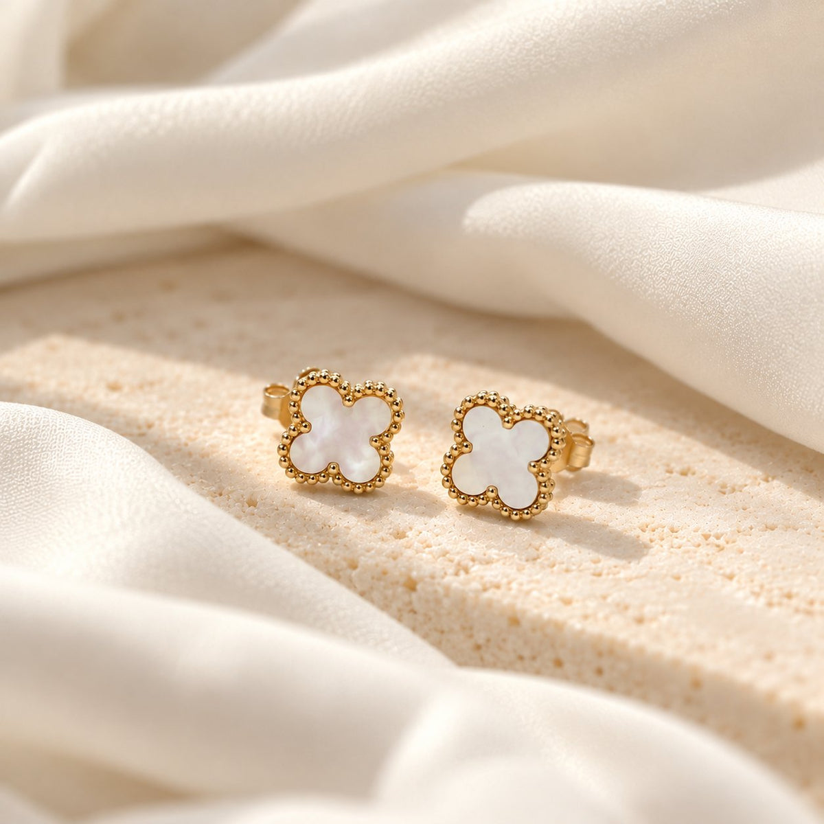 a pair of clover stud with white mother of pearl and gold vermeil 