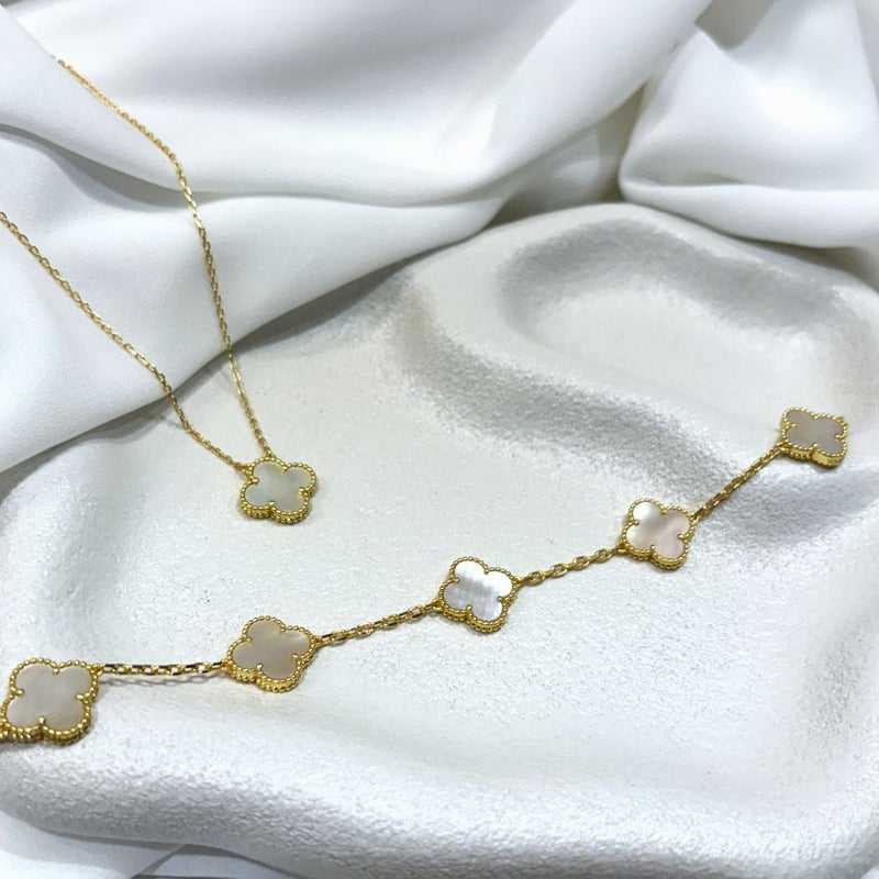 Gold necklace with white shell clover-shaped pendants 
