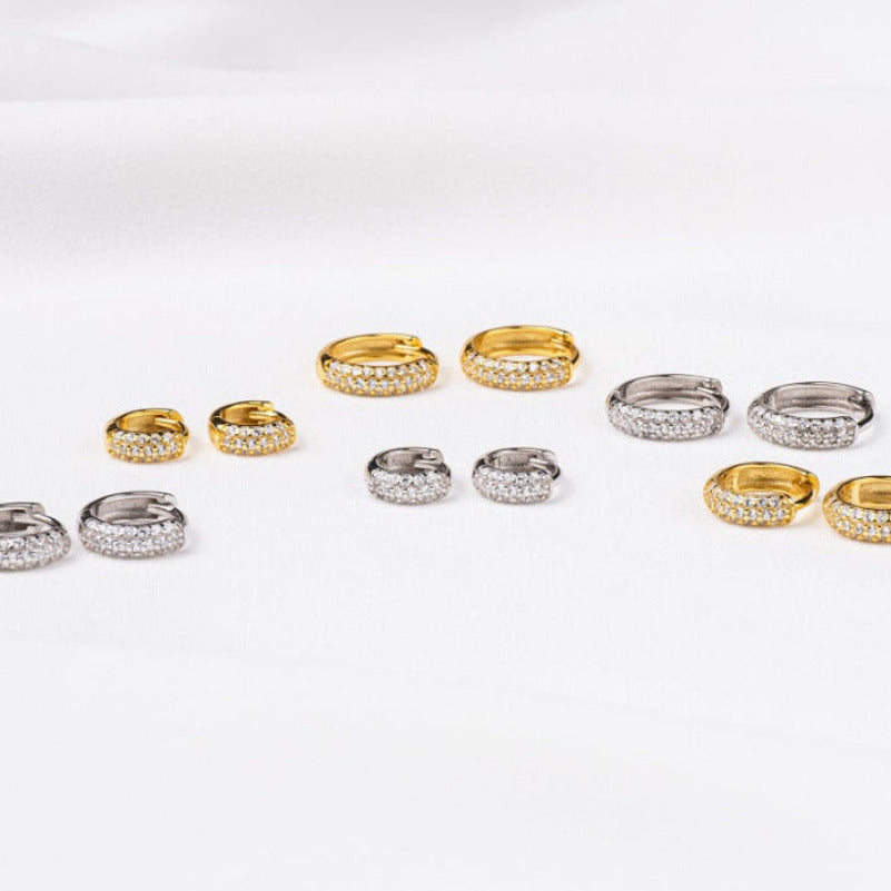 A collection of huggies sterling silver 925 hoop earrings and gold vermeil with cubic zirconia stone with different sizes.