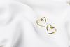 A pair of heart-shaped stud earrings made of sterling silver with gold vermeil, displayed on a white silky surface.