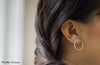 Woman wearing silver circle shaped earring