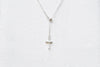 A silver chain drop necklace with a small silver cross pendant on a white background