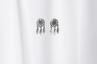 A pair of sterling silver dreamcatcher stud earrings with butterfly backs, displayed against a white background.