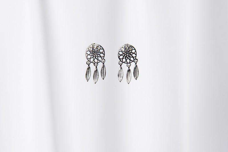 A pair of sterling silver dreamcatcher stud earrings with butterfly backs, displayed against a white background.