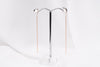 A pair of dangle earrings with a drop tail, butterfly backs, and a silver-colored post on a white stand against a white backdrop.
