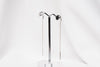A pair of dangle earrings with a drop tail, butterfly backs, and a silver-colored post on a white stand against a white backdrop.