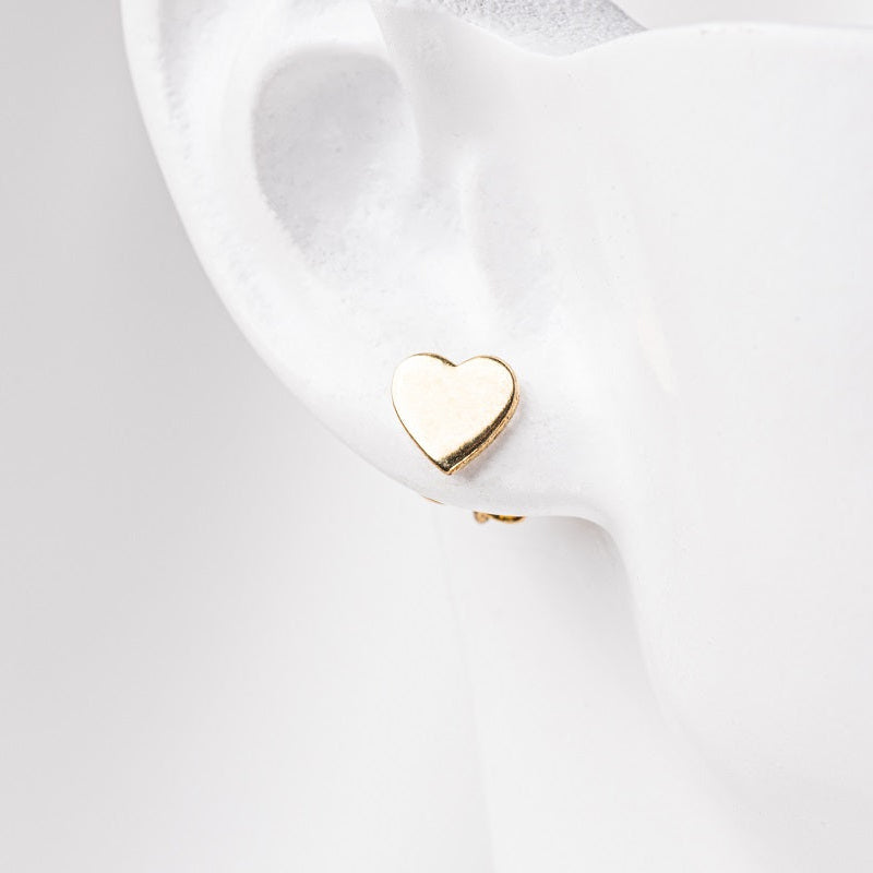 Gold vermeil heart stud on earlobe