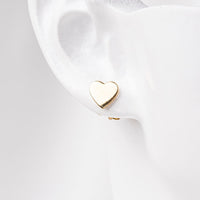 Gold vermeil heart stud on earlobe