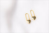 A pair of gold heart lock shaped earrings on a white background