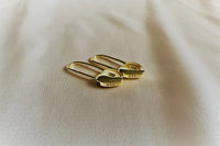 A pair of gold vermeil heart lock shaped earrings on a white background