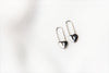 A pair of silver heart lock shaped earrings on a white background