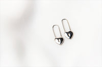 A pair of silver heart lock shaped earrings on a white background