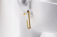 A pair of gold vermeil dangle earrings with a butterfly back design on a white background.
