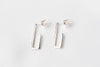A pair of sterling silver dangle earrings with a butterfly back design on a white background.