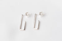A pair of sterling silver dangle earrings with a butterfly back design on a white background.