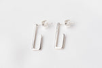 Load image into Gallery viewer, A pair of sterling silver dangle earrings with a butterfly back design on a white background.
