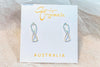 Infinity shaped silver stud earrings on a white display card with a textured white background