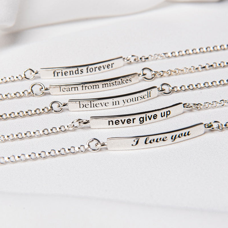 Five sterling silver bracelets with inscriptions, displayed on a white surface.
