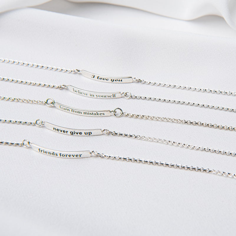 Five sterling silver bracelets with inscriptions, displayed on a white surface.