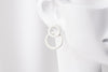 Matte silver 8 shaped stud earring on a mannequin head