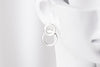 Silver 8 shaped stud earring on a mannequin head