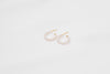 A pair of gold vermeil pearl earrings with a semi-dangle design on a white background.