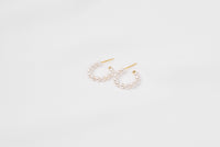 A pair of gold vermeil pearl earrings with a semi-dangle design on a white background.