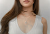 A women wear a freshwater pearl necklace with cubic zirconia stone.
