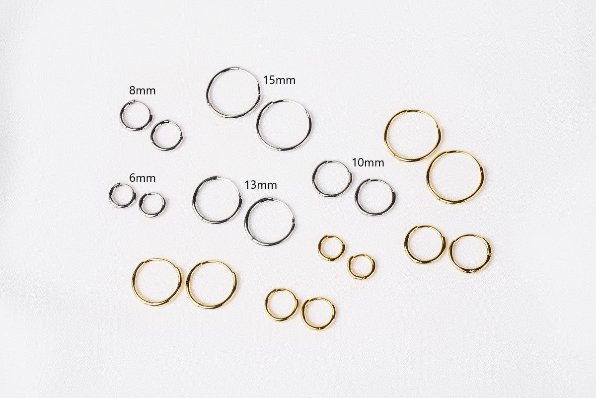 A collection of plain huggie earrings in sterling silver, displayed in various sizes with the diameters marked.