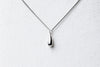 A sterling silver necklace with a chain link design and a single drop pendant.