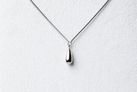 A sterling silver necklace with a chain link design and a single drop pendant.