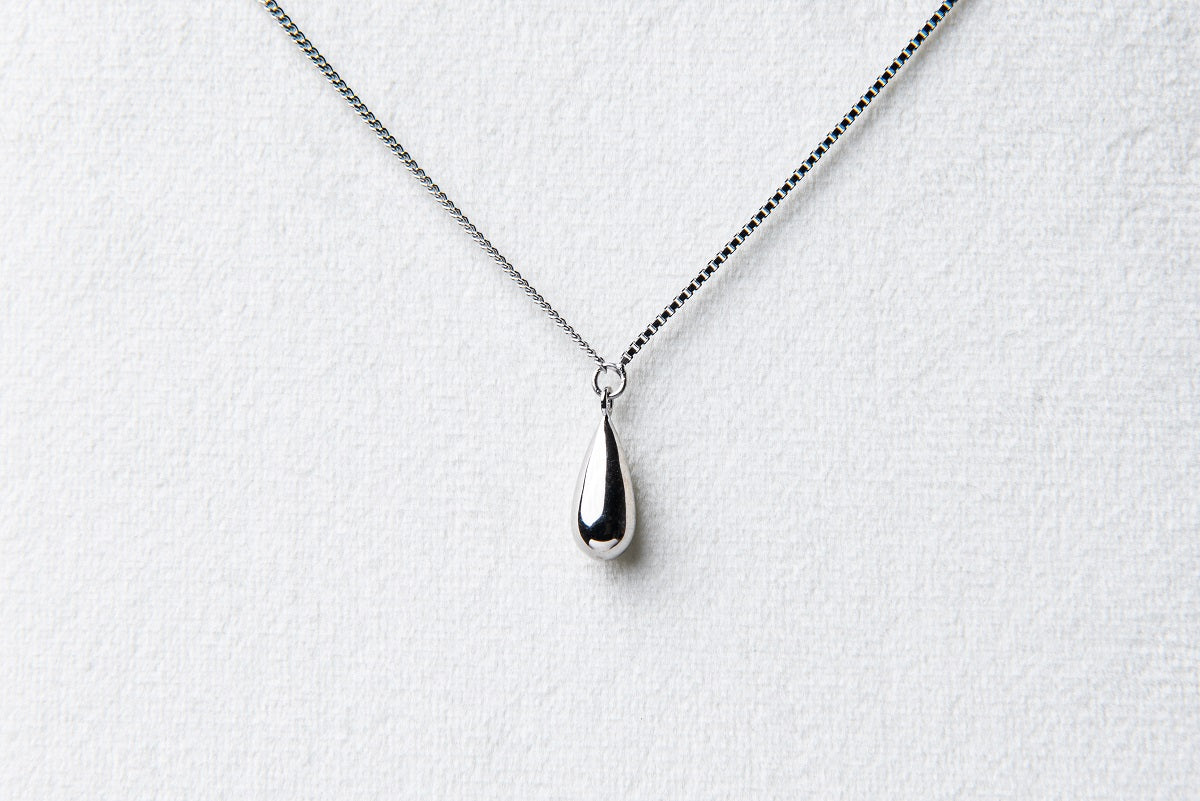 A sterling silver necklace with a chain link design and a single drop pendant.