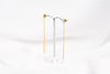 A pair of gold-colored dangle earrings with butterfly backs, displayed against a white background.