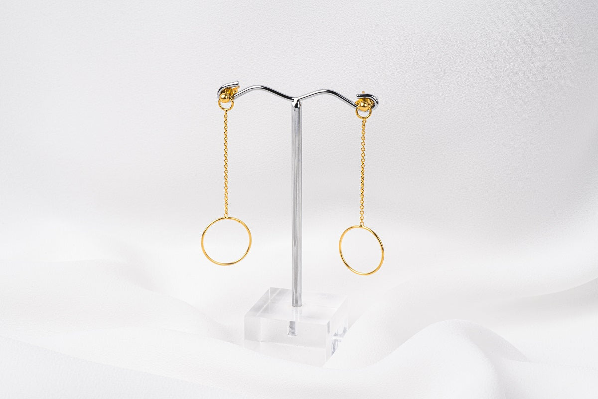 A pair of gold-colored dangle earrings with butterfly backs, displayed against a white background.