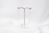 A pair of silver-colored dangle earrings with butterfly backs, displayed against a white background.