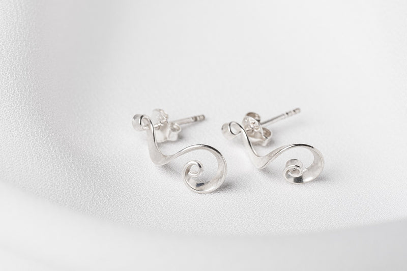 A pair of sterling silver stud earrings with a slight dangle design, displayed against a white background.