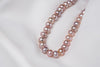 A freshwater lavender pearl displayed on a white background 