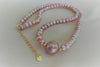 A string of pearls with a larger lavender pearl gold vermeil chain in the center displayed on a white background.