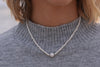 A women wearing a freshwater white pearl necklace