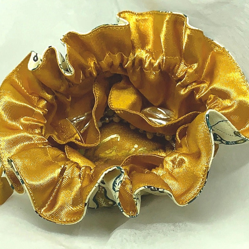 Cloth jewellery pouch on a white background