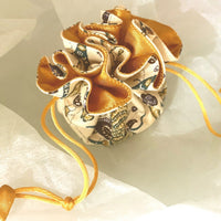 Cloth jewellery pouch on a white background