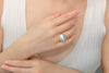 Cloose up of a womans hand wearing a silver button shaped ring